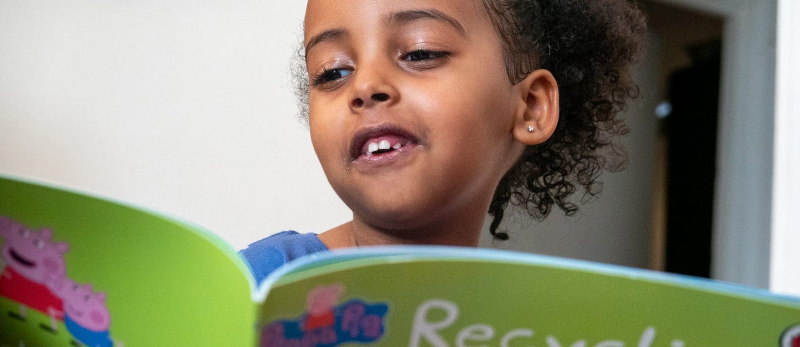 Child reading book London